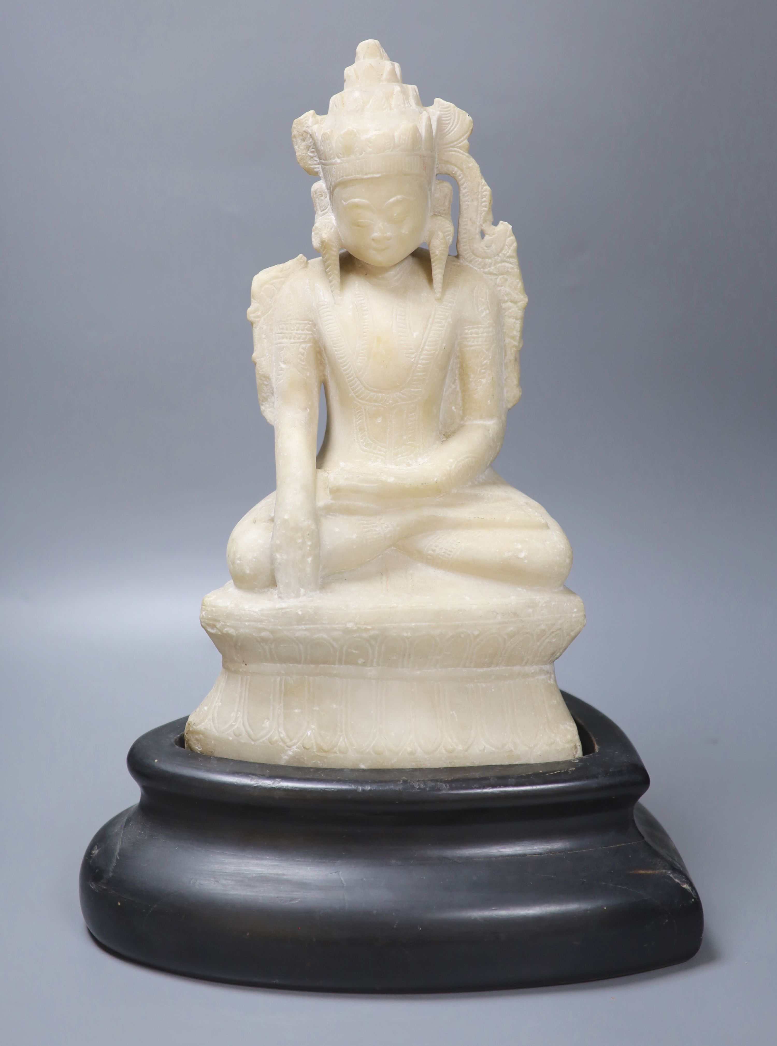 A 19th century Burmese marble crowned Jambhupati Buddha, on stand, overall height 47cm